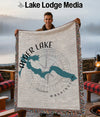 Man holding Alder Lake Washington map blanket with compass rose detail.