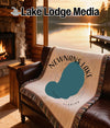Fringed blanket with Newnan's Lake, Florida map design on leather sofa.