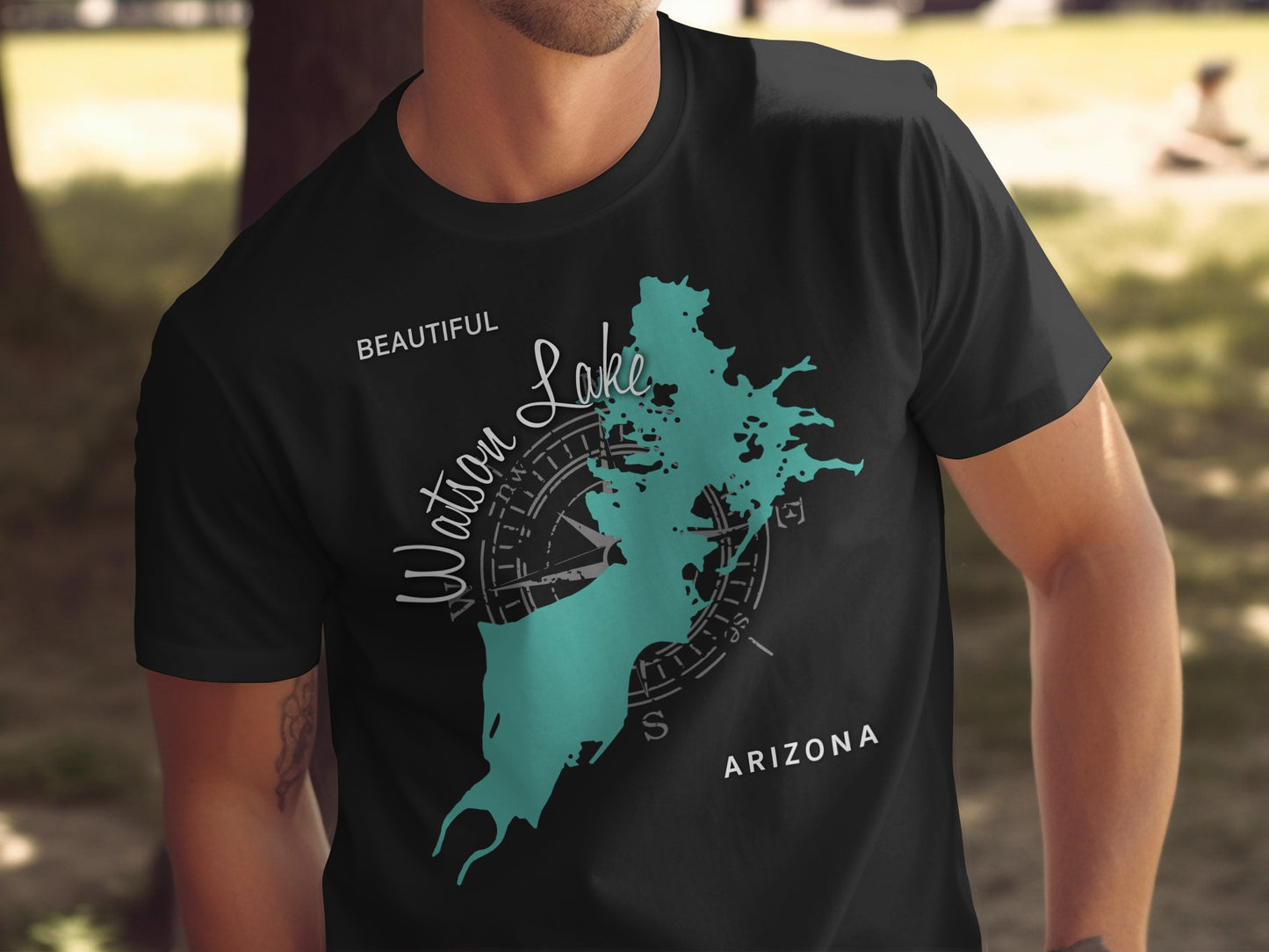 Black t-shirt with teal Watson Lake map and compass graphic.