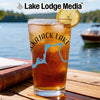 Cold iced tea in a glass with "Kajack Lake" design by a lake.