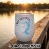 A white stemless wine tumbler rests on a wooden dock, featuring a blue map of Lake Houston, a compass graphic, and the text Lake Houston Texas.