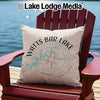 Tan pillow with Watts Bar Lake compass design on a red Adirondack chair.