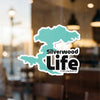 Turquoise map shape sticker with text "Silverwood Life" and copyright Lake Lodge Media LLC.