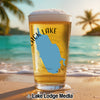 Glass of beer with a blue map outline and "BLACK LAKE" text on a beach.