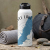 White water bottle with blue lake map and compass design, next to rolled towel and duffel bag.
