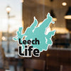 Teal Leech Life sticker with black text and white border on a window.