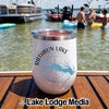 A white insulated travel tumbler with a Rathbun Lake Iowa compass logo sits on a wooden dock.