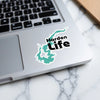 Harden Life sticker with teal lake shape on a laptop keyboard.