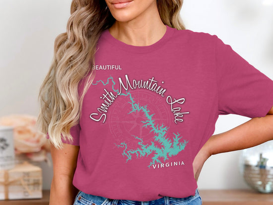 Woman wearing a pink t-shirt with a Smith Mountain Lake map and compass design.