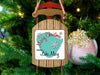 Wooden sled ornament on Christmas tree with "Merry Christmas from Lake Mary" text.
