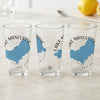 Three clear glasses with blue Lake Mascuppic map and compass designs.