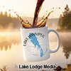 White mug with Lake Winnipeg map graphic, coffee splashing in.