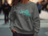 Dark gray sweatshirt with a compass rose and map of Canyon Lake, Texas.