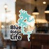 Blue Ridge Life sticker with teal lake outline on a window.