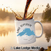 White mug with Lake Superior map and compass, coffee pouring into it.