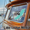 Turquoise Carlyle Life map sticker on a boat window, Lake Lodge Media logo.