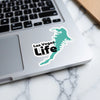Las Vegas Life sticker in turquoise on a laptop keyboard.
