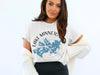 White t-shirt with blue lake map and compass graphic reading "Lake Minnetonka, Minnesota".