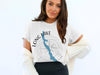 White t-shirt with blue Long Lake map graphic and compass rose, "MAINE" text.