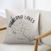 Pillow with "Highland Lakes Texas" text and compass design on a chair.