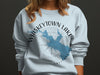 Light blue sweatshirt with Whiskeytown Lake, California map, compass, and text.