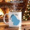 White mug with Ossipee Lake map and compass design, steaming coffee.
