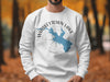 White sweatshirt with blue Whiskeytown Lake map and compass graphic.