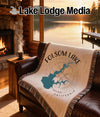 Throw blanket with Folsom Lake map design on brown leather couch.