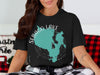 Black t-shirt with teal Sebago Lake map graphic and compass rose. Maine text.