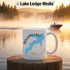 White mug with Arcadia Lake map and compass graphic, with a lake scene background.