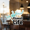 Turquoise Powell Life sticker with lake outline on a reflective surface.