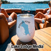 A white insulated wine tumbler with a Jordan Pond Maine graphic sitting on a boat table.