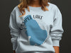 Light blue sweatshirt with Ossipee Lake, New Hampshire graphic.
