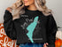 Black sweatshirt with "Long Pond Lake New Hampshire" and compass design.