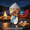 Glass with Saratoga Lake design on table next to s'mores ingredients and campfire.
