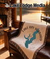 Woven throw blanket with Lake Ray Hubbard map and compass on leather couch.