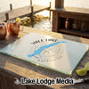 A glass cutting board featuring a blue map of Yale Lake, Washington, on a wooden outdoor bar.