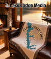 Cedar Creek Lake Texas map on a fringed blanket displayed on a leather sofa.