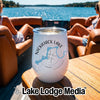 A white stainless steel wine tumbler with a compass and Nickajack Lake Tennessee graphic on a boat table.