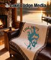 Tapestry blanket with Lake Tapps, Washington map design on a leather sofa.