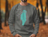 Crewneck sweatshirt with teal Lake Winnebago outline and compass rose.