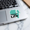 Turquoise Sebago Life sticker on a laptop keyboard.