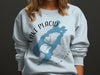 Pale blue sweatshirt with Lake Placid New York map and compass design.