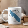 White mug with blue Onondaga Lake outline, compass, and text.