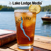 Glass of iced tea with "Cayuga Lake" design, compass, and lemon slice.