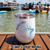 A white tumbler with a Kerr Lake Virginia compass graphic rests on a wooden dock with people and boats in the background.