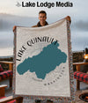 Woven blanket with Lake Quinault map and text, held by a smiling man.