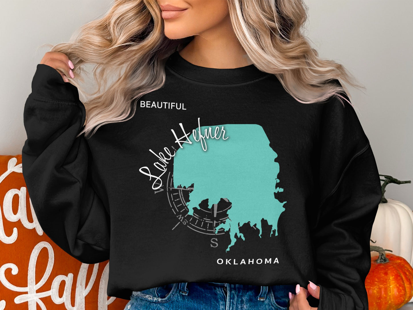 Black sweatshirt with teal Lake Hefner map and compass graphic.