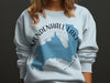 White crew neck sweatshirt with a blue outline map and "Mendenhall Lake Alaska" text.