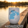 A white insulated wine tumbler featuring a blue map of Floyd Lake, Minnesota on a wooden dock at sunset.